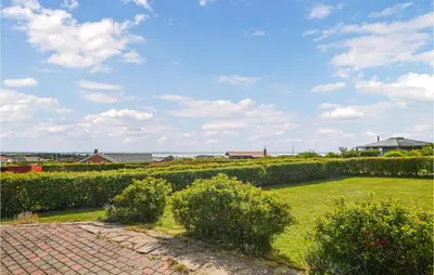 a garden with hedges and a brick walkway at Holiday Home Vinderup With Fireplace 07 in Vinderup