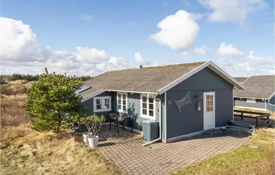 a blue and white house with a patio at Holiday Home Frøstrup With Fireplace 10 in Frøstrup