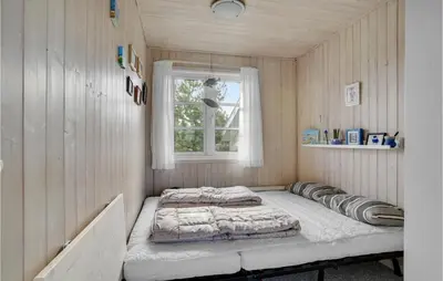 a bed in a room with a window at Holiday Home Frøstrup With Fireplace 10 in Frøstrup