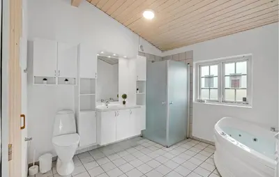 a bathroom with a tub and a toilet and a sink at Beautiful Home In Farsø With Kitchen in Farsø