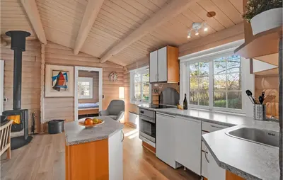 a kitchen with wooden walls and a wooden ceiling at Beautiful Home In Farsø With Kitchen in Farsø