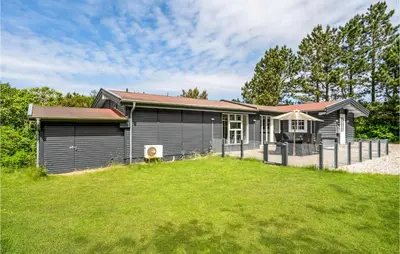 a house with a grass yard in front of it at Beautiful Home In Farsø With Kitchen in Farsø
