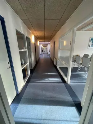 an empty hallway in an office building with chairs at Roslev Vandrerhjem-Hostel in Roslev