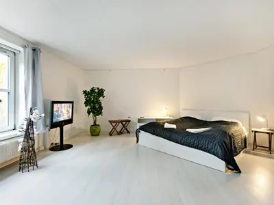 a bedroom with a bed and a tv in it at Løgstør Parkhotel in Løgstør
