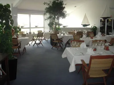 a dining room with white tables and chairs at Løgstør Parkhotel in Løgstør