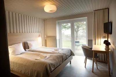 a bedroom with a large bed and a window at HotelVFjorden in Lemvig