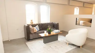 a living room with a couch and a table at HotelVFjorden in Lemvig