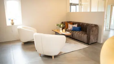 a living room with two chairs and a couch at HotelVFjorden in Lemvig