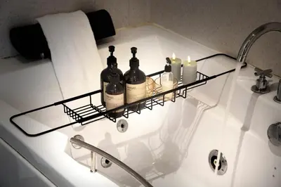 a bathroom sink with a shelf with bottles and candles at HotelVFjorden in Lemvig
