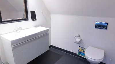 a white bathroom with a sink and a toilet at HotelVFjorden in Lemvig