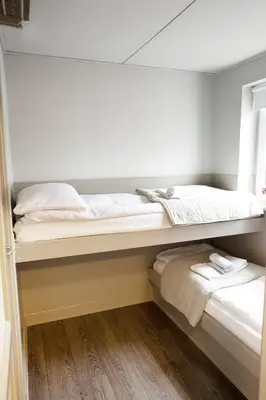 two bunk beds with towels on them in a room at HotelVFjorden in Lemvig