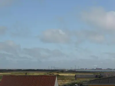 a view of a field with buildings and a sky at Harboøre Hotel in Harboør