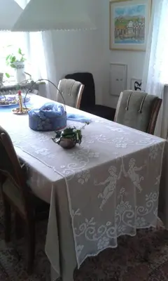 a table with a white table cloth on it at Porshøjvej in Skive