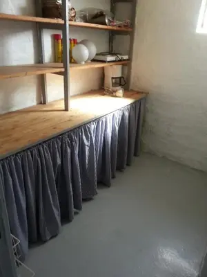 a room with a counter with wooden shelves at Porshøjvej in Skive