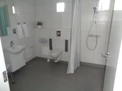 a bathroom with a shower and a toilet and a sink at Hotel St. Binderup in Store Binderup