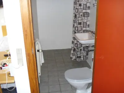 a bathroom with a toilet and a sink at Hotel St. Binderup in Store Binderup