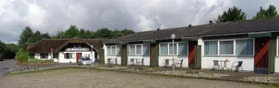 a building with chairs parked in front of it at Hotel St. Binderup in Store Binderup