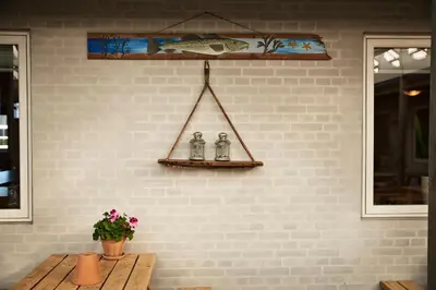 a wall with a table and a shelf with at Danhostel Thyborøn in Thyborøn
