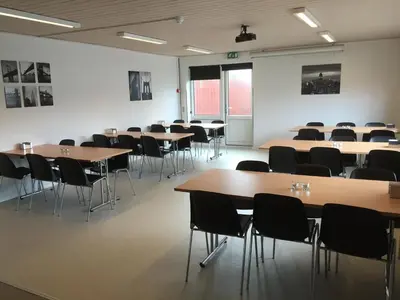 a classroom with tables and chairs in a room at Danhostel Thyborøn in Thyborøn
