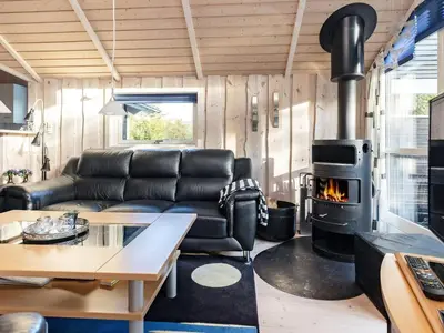 a living room with a couch and a stove at 7 person holiday home in Løgstør-By Traum in Trend
