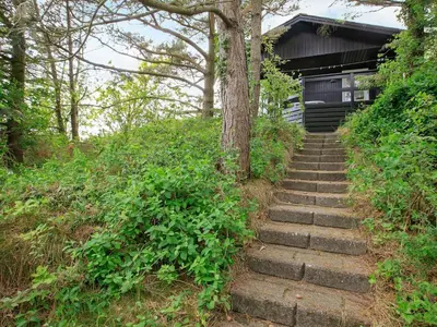 a set of stairs leading up to a building at Secluded Beach Retreat - By Traum Ferienwohnungen in Lihme