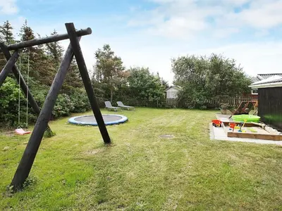 a wooden pole in a yard with a trampoline at 8 person holiday home in Løgstør-By Traum in Trend
