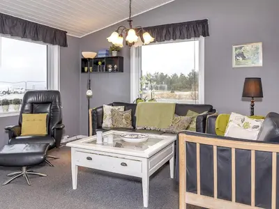 a living room with a couch and two chairs at 8 person holiday home in Løgstør-By Traum in Trend