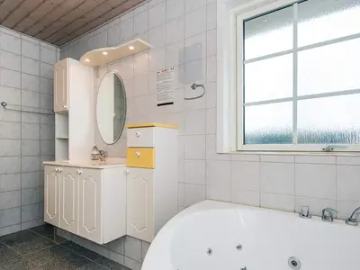 a white bathroom with a tub and a sink at 12 person holiday home in Harboøre-By Traum in Vrist