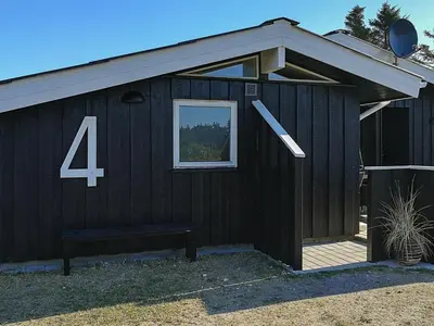 a black building with the number four on it at 9 person holiday home in Løkken-By Traum in Grønhøj