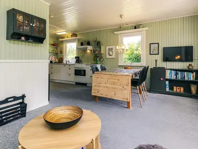 a kitchen with a table and a dining room at 2 person holiday home in Thyholm-By Traum in Thyholm