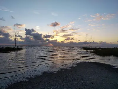 a large body of water with a sunset in the background at 6 person holiday home in Thisted-By Traum in Sønder Vorupør