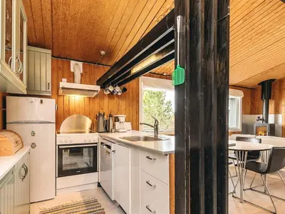 a kitchen with white appliances and a table in it at 6 person holiday home in Thisted-By Traum in Sønder Vorupør