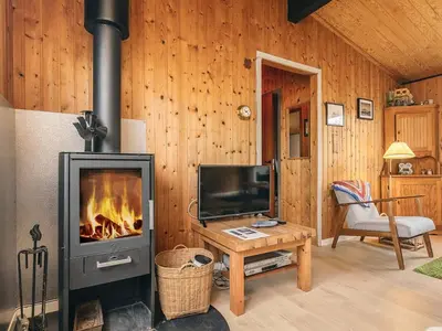 a living room with a fireplace and a television at 6 person holiday home in Thisted-By Traum in Sønder Vorupør