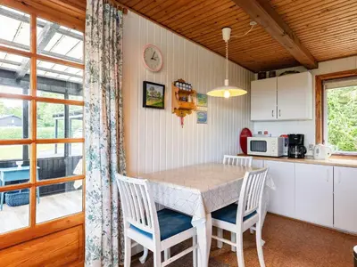 a kitchen with a table and chairs in a room at 5 person holiday home in Roslev-By Traum in Sønder Thise