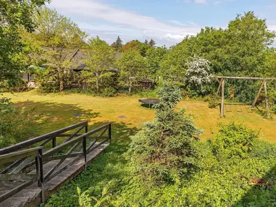 an aerial view of a garden with a wooden bridge at 19 person holiday home in Løgstør-By Traum in Trend