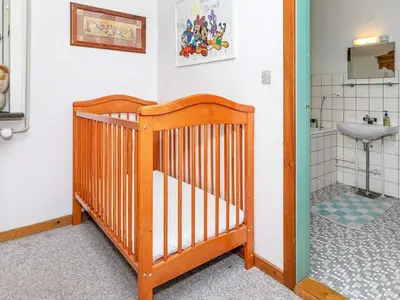 a crib in a bathroom with a sink at 19 person holiday home in Løgstør-By Traum in Trend