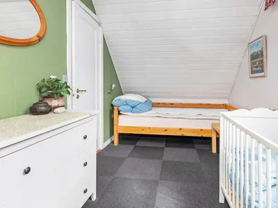 a small room with a crib and a bunk bed at 19 person holiday home in Løgstør-By Traum in Trend