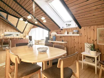 a dining room with a wooden table and chairs at 6 person holiday home in Saltum-By Traum in Saltum