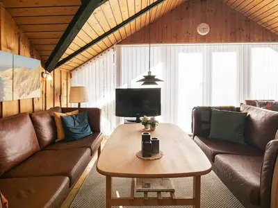 a living room with a couch and a table at 6 person holiday home in Saltum-By Traum in Saltum