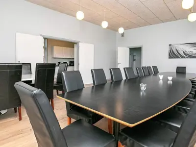 a conference room with a black table and chairs at 26 person holiday home in Roslev-By Traum in Åsted