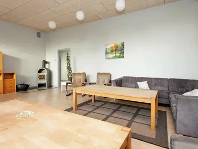 a living room with a couch and a table at 26 person holiday home in Roslev-By Traum in Åsted