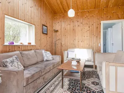 a living room with a couch and a table at 7 person holiday home in Struer-By Traum in Humlum