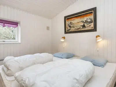 a room with two beds and a picture on the wall at 7 person holiday home in Struer-By Traum in Humlum