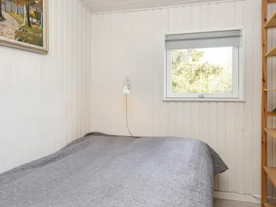 a bedroom with a bed and a window at 7 person holiday home in Struer-By Traum in Humlum