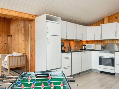 a kitchen with white cabinets and a pool table at 7 person holiday home in Struer-By Traum in Humlum