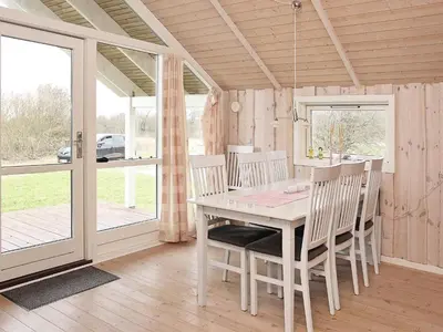 a dining room with a white table and chairs at 6 person holiday home in Vestervig-By Traum in Vestervig