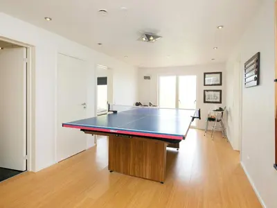 a ping pong table in the middle of a room at Luxury Seaside Retreat - By Traum Ferienwohnungen in Tranum Strand