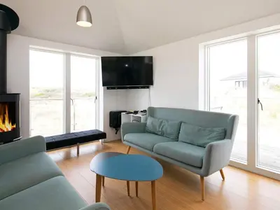 a living room with a couch and a fireplace at Luxury Seaside Retreat - By Traum Ferienwohnungen in Tranum Strand