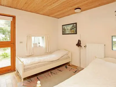 a bedroom with two beds and a window at Luxury Retreat with Pool - By Traum Ferienwohnungen in Hvalpsund