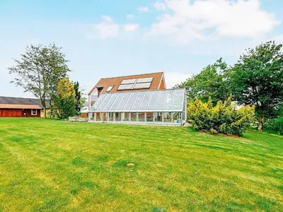 a house with a large lawn in front of it at Luxury Retreat with Pool - By Traum Ferienwohnungen in Hvalpsund